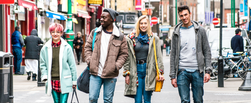 Group of young people walking down a city street